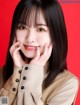 A woman with long black hair and bangs posing for a picture.