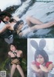 A woman in a bunny costume is sitting in the water.