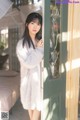 A woman standing in front of a green door.